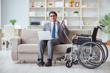 Dsabled businessman on wheelchair working home