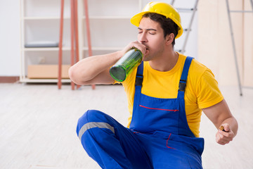 Floor repairman drinking alcohol during break