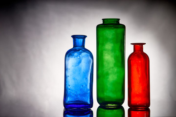 three colored bottles