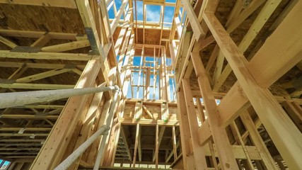Moving through a modern home construction site under bright sunlight