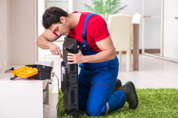 Professional repair engineer repairing broken tv