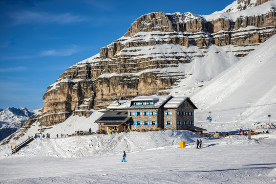 MADONNA DI CAMPIGLIO, ITALY-21 November 2014:Panoramic winter landscape of Dolomiti mountain and Mountain shelter in Madonna di Campiglio. The ski slope and skiers at Passo Groste ski area