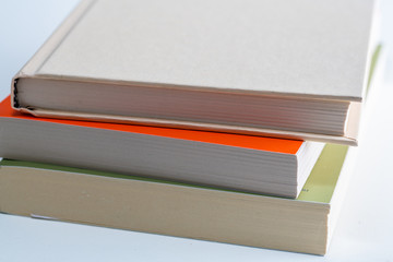 Stack of books and pen, fountain pen, pencil isolated