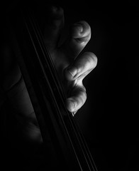 A classically trained musician plays cello, close up black and white © James