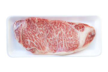 raw wagyu sirloin beef wrapped in plastic wrap with foam tray isolated on white background