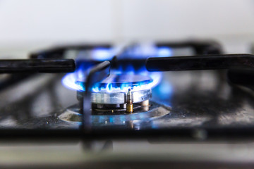 Gas hobs on the stove. Burning blue gas. Gas burners
