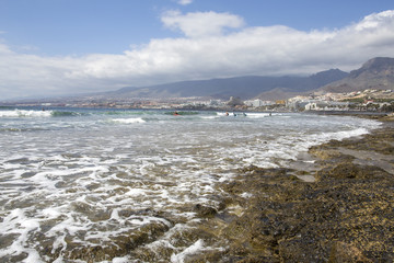 Beach in Las Americas. Beach for surfers, in Tenerife, Spain. Stone beach. Playa de las Americas, Tenerife.