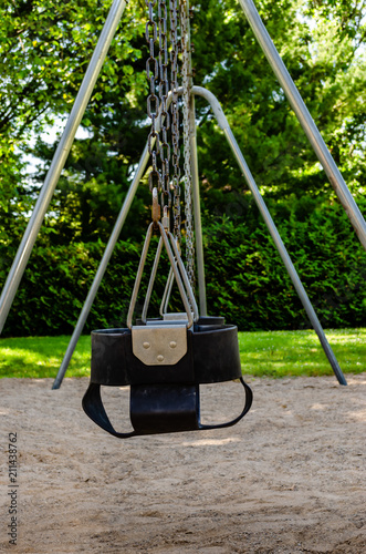 Symetrical Row Of Child Swing Seats On A Steel Swing Set