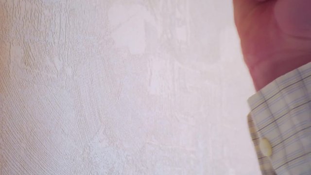 male fist aggressively hitting the wall.