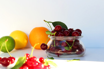 Still life of fresh berries and fruits. Vitamin supplement. Dessert for gourmets. Dietary and vegetarian dishes. Add to your diet. Side view, selective focus.