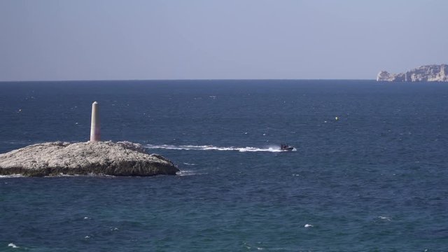 A diving boat speeding along the mediterranean coast near Marseille