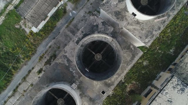 Overhead aerial view of disintegrated cooling towers of industrial complex in Albania