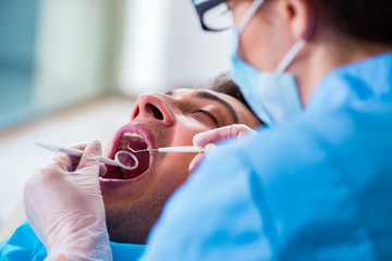 Fototapeta premium Man patient visiting dentist for regular check-up