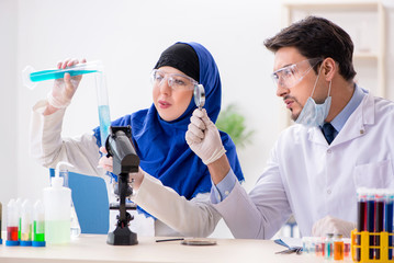 Two chemists working in the lab