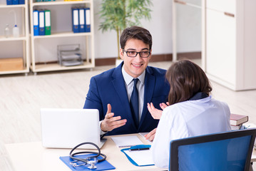 Businessman discussing health issues with doctor