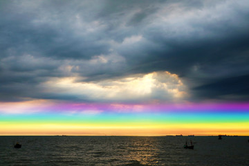 Obraz premium rainbow back dark cloud on sea. concept god bless, wish