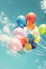 Deurstickers Colorful festive balloons over blue sky with a retro vintage instagram filter effect. © jakkapan