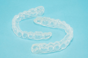 Dental  tools  and retainer orthodontic appliance on the blue background.