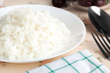 Cooked plain white jasmine rice  serve in. a dish. Close up on the table. Horizontal