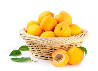 Fresh apricots in the basket are isolated on a white background.