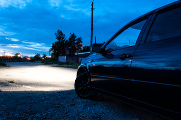 Car side view. Polished body. Night, summer.