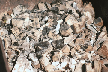 Hot coals in the grill brazier close-up.