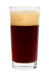 Cold glass of dark beer or kvass with foam isolated on white background.