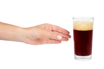 Hand with cold glass of dark beer or kvass with foam isolated on white background.