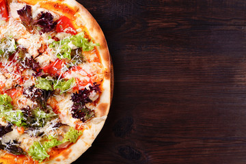 Restaurant, food delivery, pizzeria menu concept. Appetizing vegetarian pizza with lettuce ad garlic sauce flat lay with copy space. Delicious classical recipe, traditional Italian snack