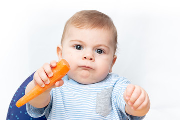 Baby playing with carrot