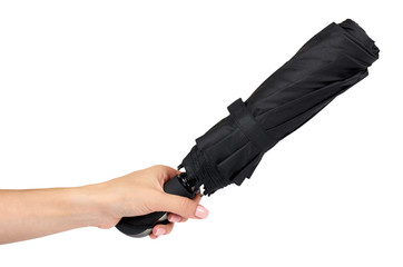 Fototapeta premium Single closed black umbrella with hand isolated on a white background.