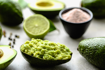 Traditional guacamole dip in avocado peel, healthy food for party sharing