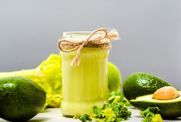 Vegetable drink with green vegetables, jar of smoothie with avocado, healthy breakfast and vegetarian food concept