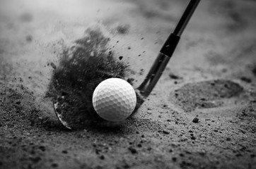 Golfers are hitting the golf ball by sand blasting