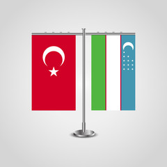 Table stand with flags of Turkey and Uzbekistan.Two flag. Flag pole. Symbolizing the cooperation between the two countries. Table flags