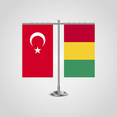 Table stand with flags of Turkey and Guinea.Two flag. Flag pole. Symbolizing the cooperation between the two countries. Table flags