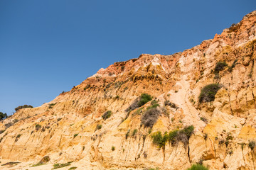 Fototapeta premium Eroded stone cliffs at the beach Praia da Falesia in Algarve of south Portugal