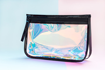 Holographic colors cosmetic bag on pastel tones background