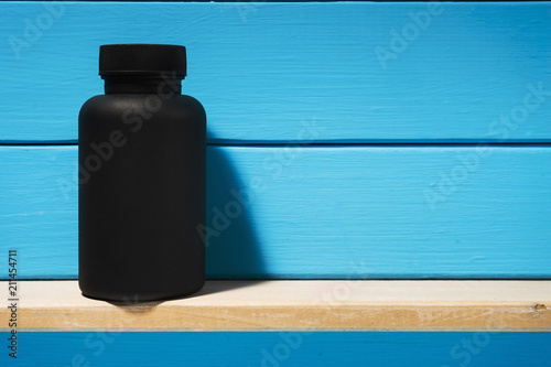 Download Black Bottle For Pills On A Black Glass Table Beautiful Yellow Background Stock Photo And Royalty Free Images On Fotolia Com Pic 192635625 PSD Mockup Templates