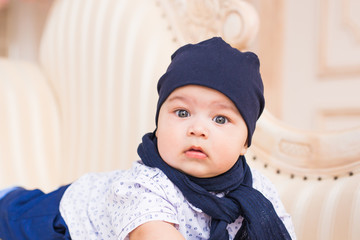 Cute newborn baby boy in sunny room