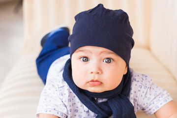 Cute newborn baby boy in sunny room