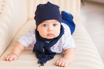 Adorable baby boy in sunny bedroom. Newborn child relaxing