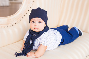 Cute newborn baby boy in sunny room