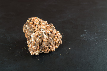 One piece of milk chocolate with puffed rice and raisins