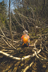 Boy hiker with backpack in a deep forest