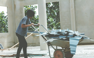 Children working at construction site for world day against children labour concept:
