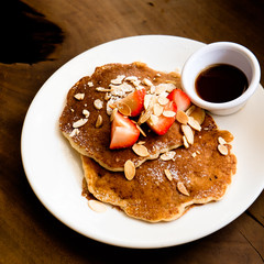 Pancake with strawberries and almond flakes