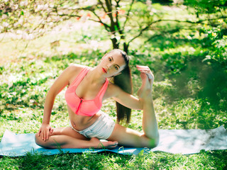 Naklejka na ściany i meble Young sport woman exercising - outside in nature