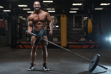 Plakat Brutal strong bodybuilder athletic men pumping up muscles with dumbbells