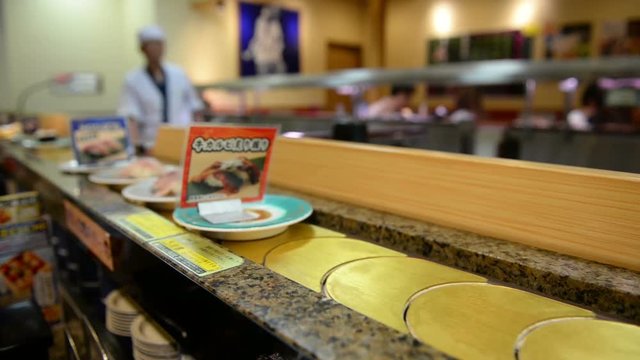 Sushi restaurant where sushis and other food are placed on a rotating conveyor belt